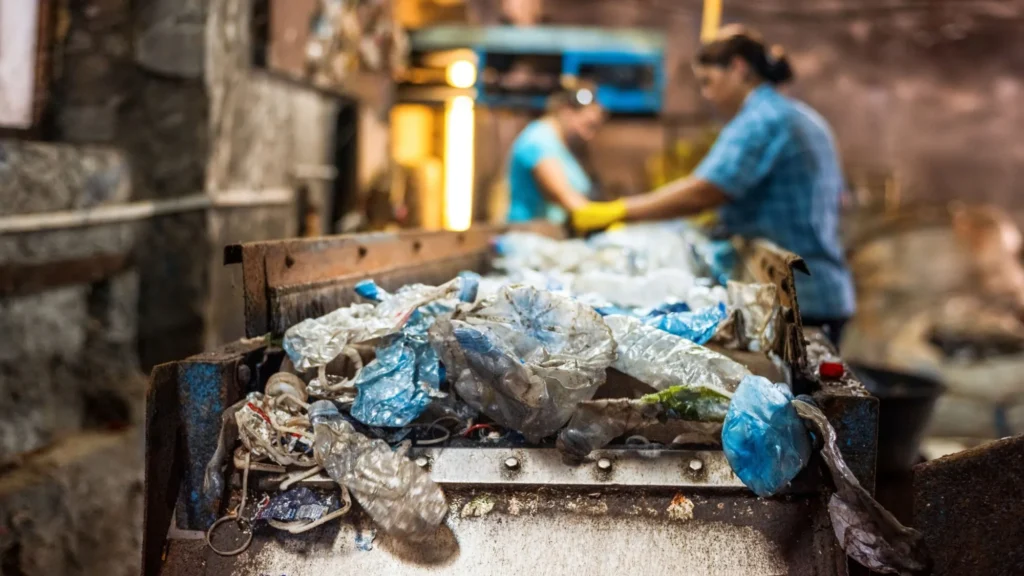 Plastic garbage conveyor belt waste recycling factory workers background